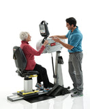 SCIFIT PRO1 Upper Body Ergometer with premium seat. Older female using arm crank while trainer assists during rehab exercise session.